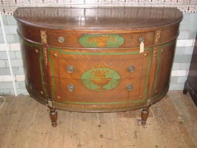 Appraisal: A MAHOGANY COMMODE of demi lune form with parquetry banding