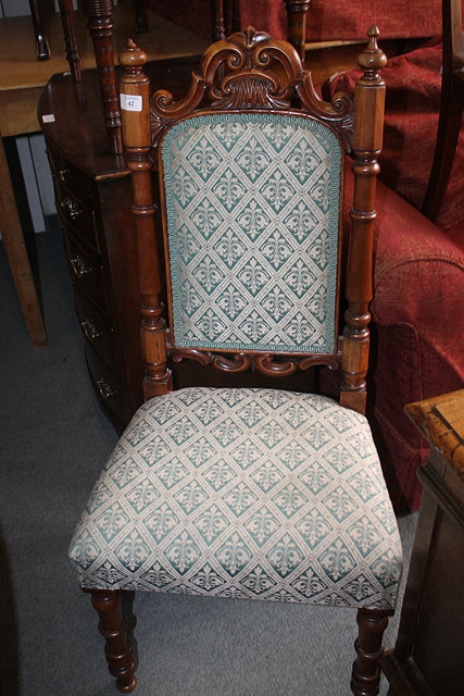 Appraisal: A VICTORIAN WALNUT NURSING CHAIR with carved cresting rail and