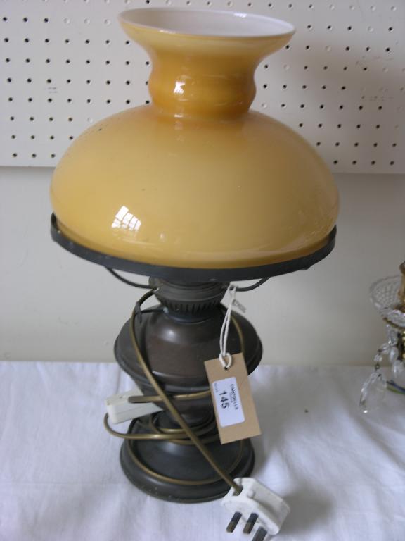 Appraisal: A brass table lamp converted from oil to electric with