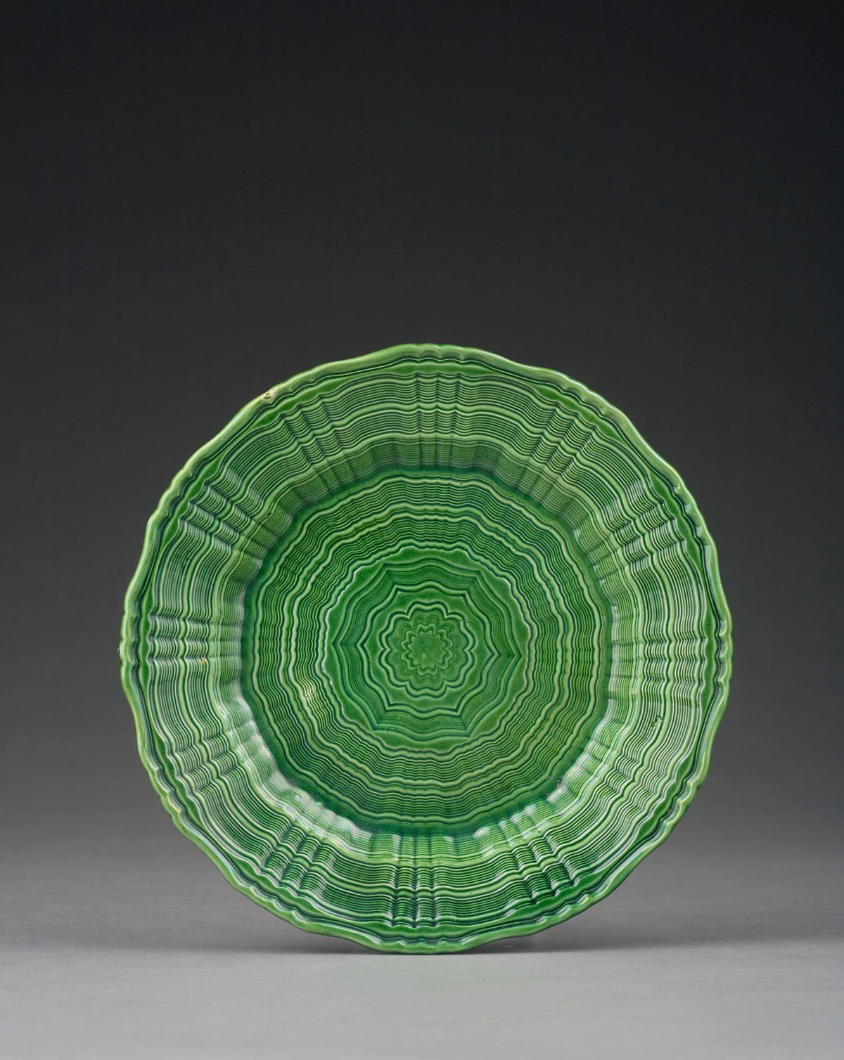 Appraisal: RARE STAFFORDSHIRE CREAMWARE GREEN-GLAZED PLATE CIRCA Engine-turned with horizontal wavy