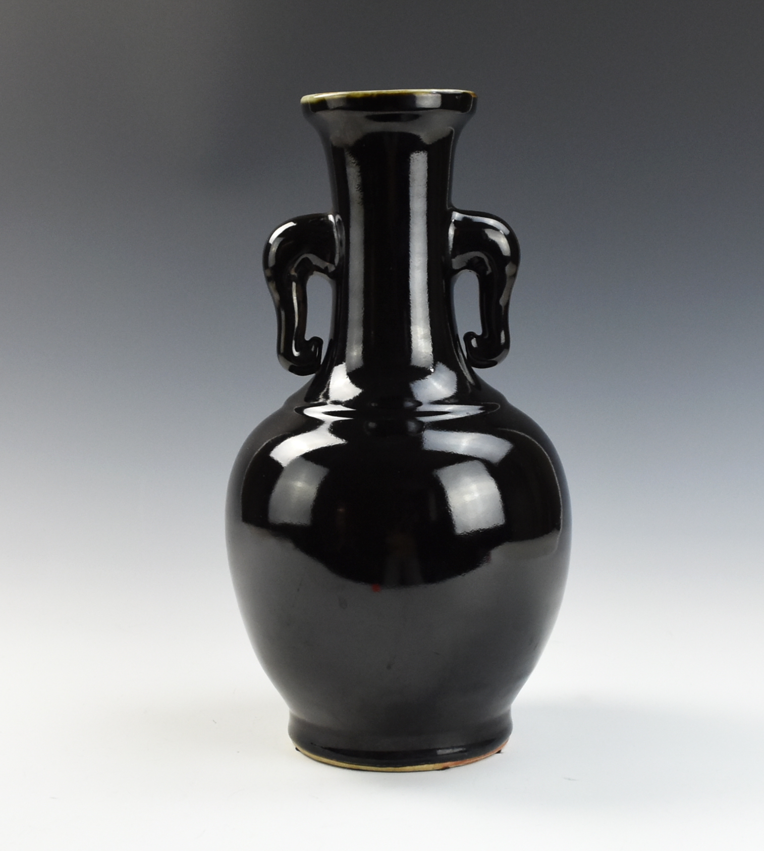 Appraisal: CHINESE BLACK GLAZED ELEPHANT HANDLE VASE with an ovoid body