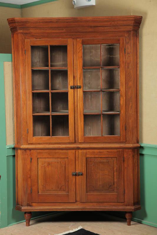 Appraisal: CORNER CUPBOARD Two piece walnut with step molded cornice two