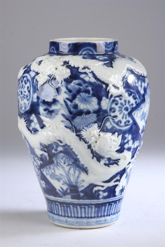 Appraisal: JAPANESE BLUE AND WHITE PORCELAIN DRAGON VASE Meiji period Molded