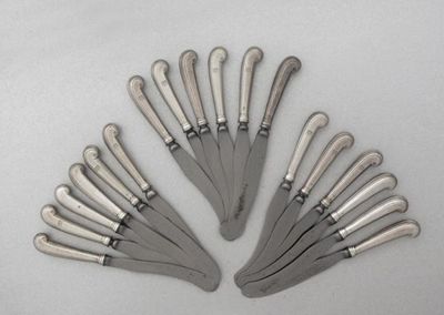 Appraisal: Eighteen George II side knives with reeded pistol handles including