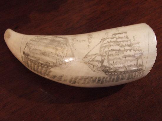 Appraisal: A MARINE IVORY SCRIMSHAW WHALE'S TOOTH engraved with two whaling