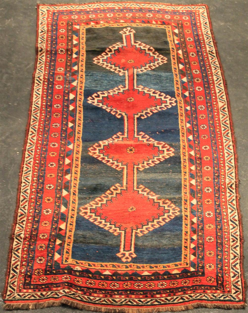 Appraisal: PERSIAN SHIRAZ RUG four diamond medallions on a blue field