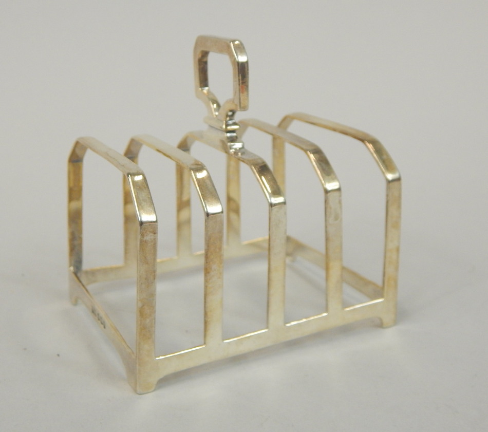 Appraisal: A silver four division toast rack of faceted form Birmingham