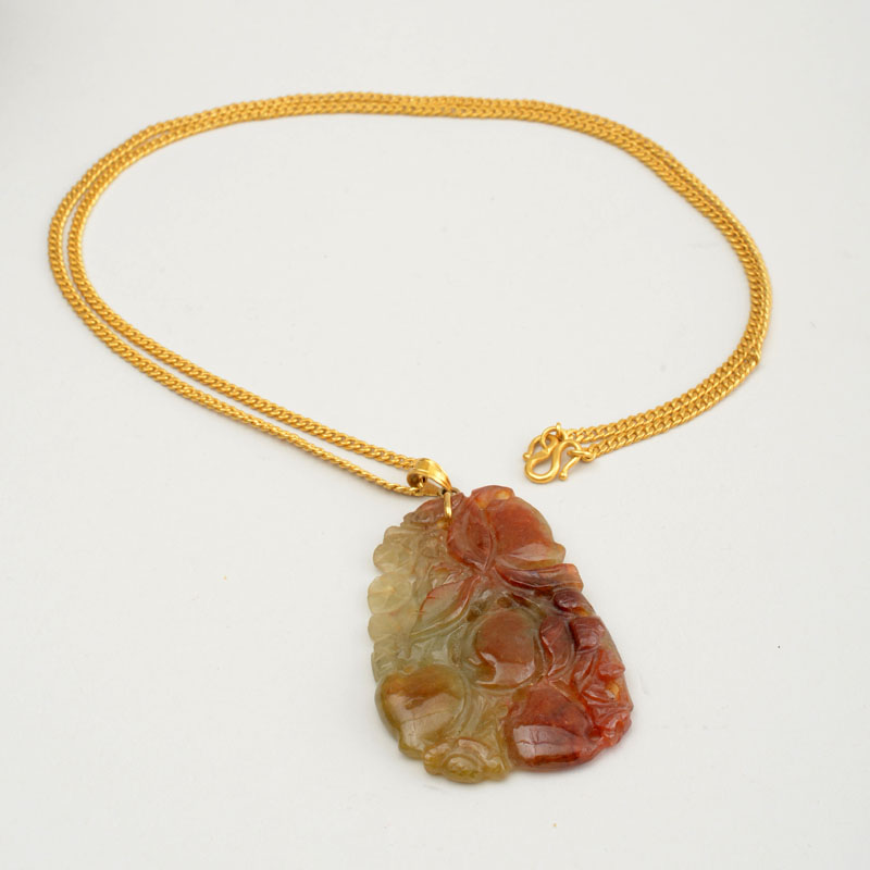 Appraisal: CARVED JADE PENDANT ON K YELLOW GOLD CHAIN Chain stamped