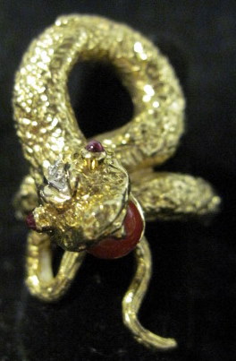 Appraisal: karat yellow gold diamond coral and ruby 'snake' ring italy