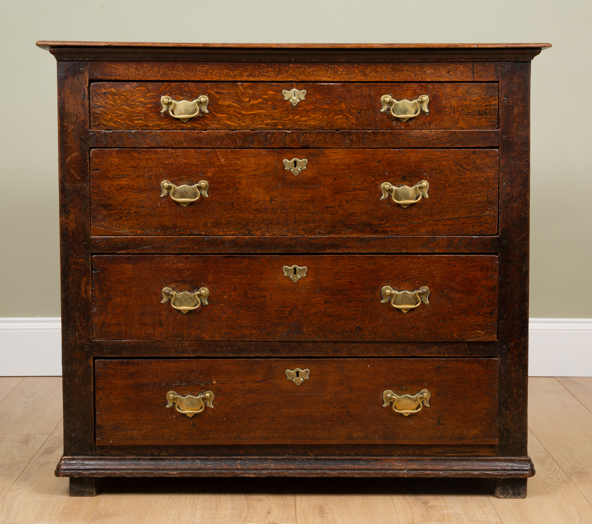 Appraisal: An antique rustic oak chest of four long drawers th