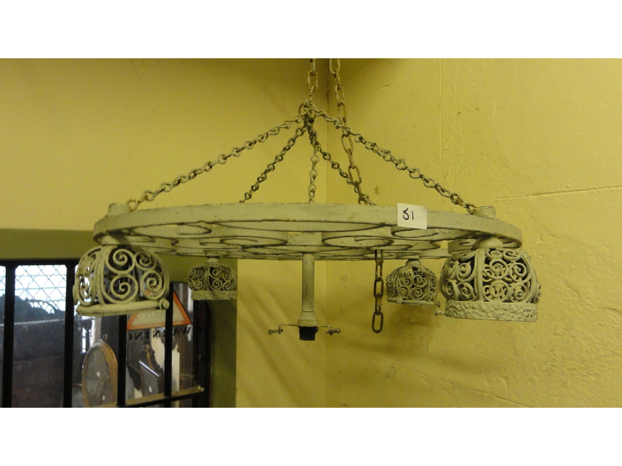 Appraisal: A hanging ironwork ceiling light of circular form with scrollwork