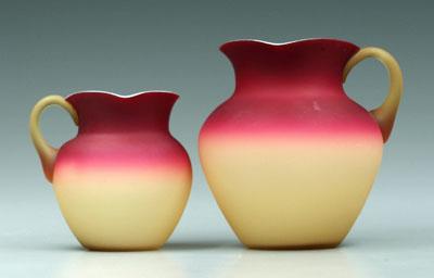 Appraisal: Two Wheeling peachblow pitchers satin finish and amber handles square