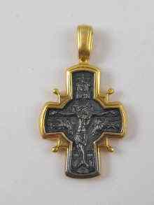 Appraisal: A yellow and white metal crucifix pendant x cm