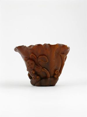 Appraisal: A Chinese rhinoceros horn libation cup naturalistically carved as a