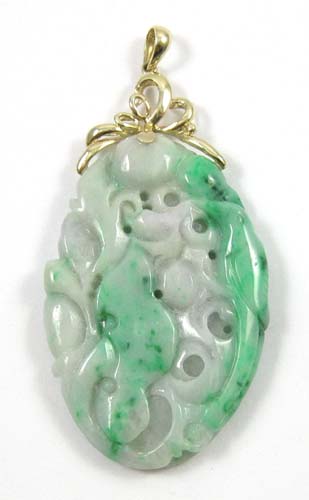 Appraisal: JADE AND FOURTEEN KARAT GOLD PENDANT set in yellow gold