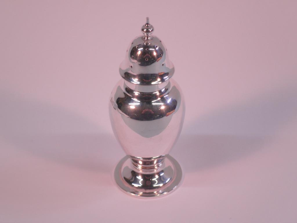 Appraisal: A silver baluster shaped pepper pot with a turned finial