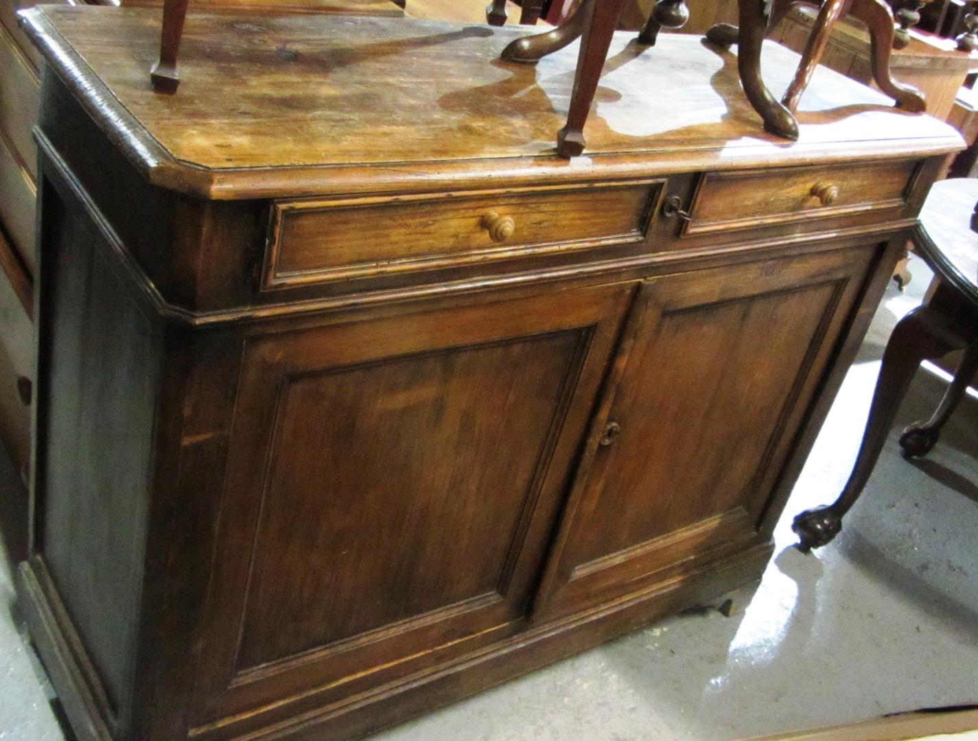 Appraisal: A French stained pine side cabinet with two drawers and