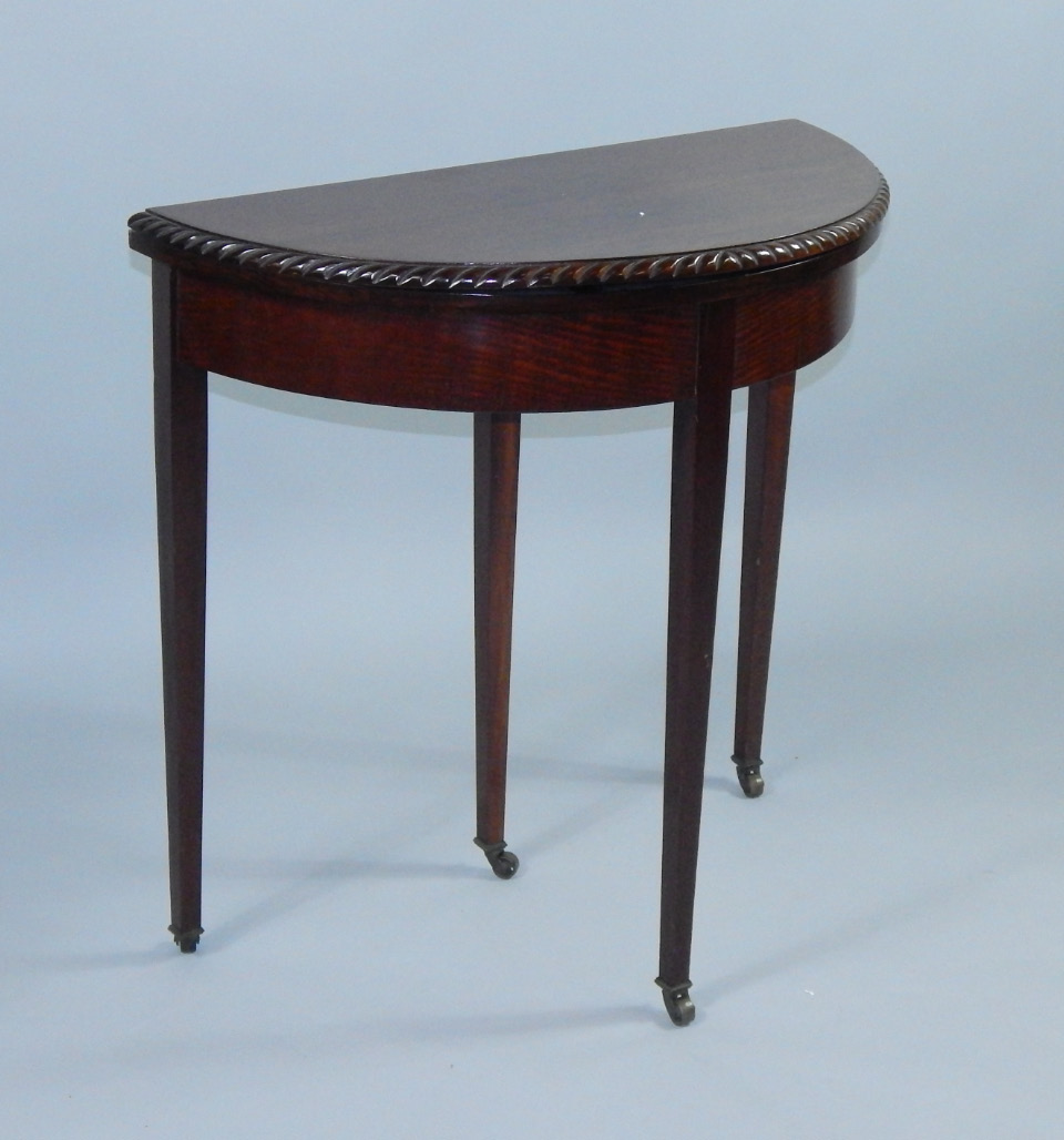 Appraisal: An Edwardian mahogany fold over card table the demi lune