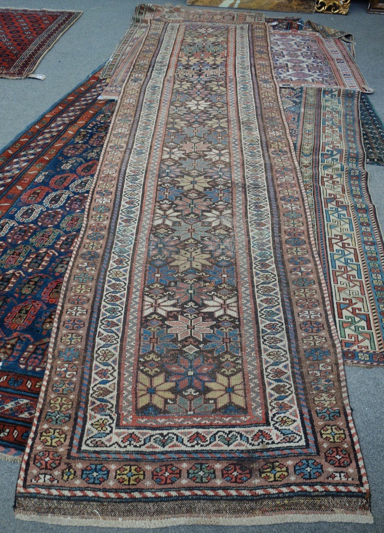 Appraisal: A North West Persian runner the brown field with a