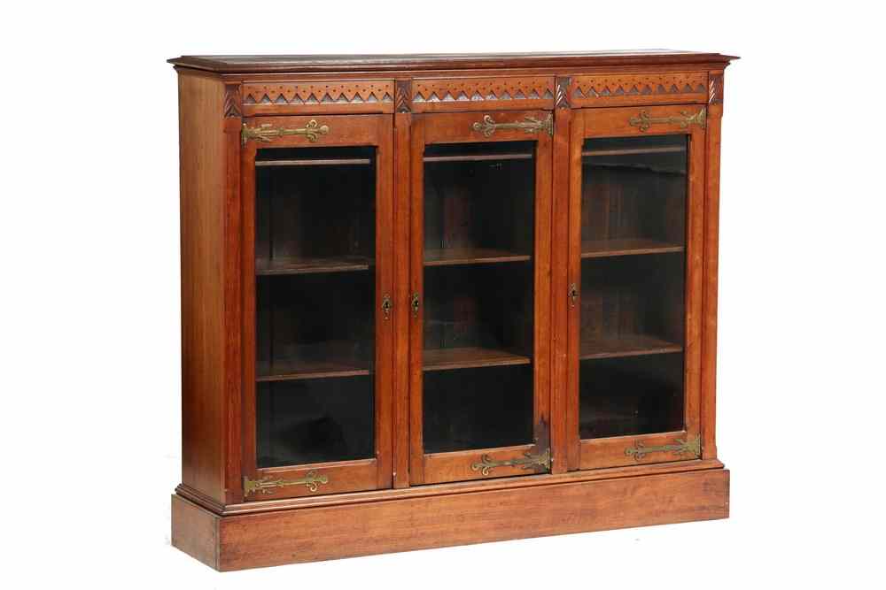 Appraisal: BOOKCASE - Aesthetic period Victorian walnut three door bookcase Molded