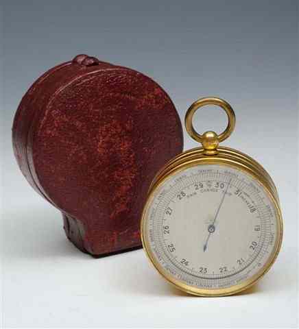 Appraisal: A DOUBLE SIDED BRASS CASED ANEROID BAROMETER THERMOMETER AND COMPASS