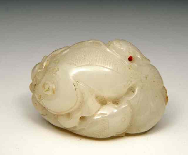 Appraisal: A CHINESE MUTTON FAT JADE PEBBLE carved as gold fish