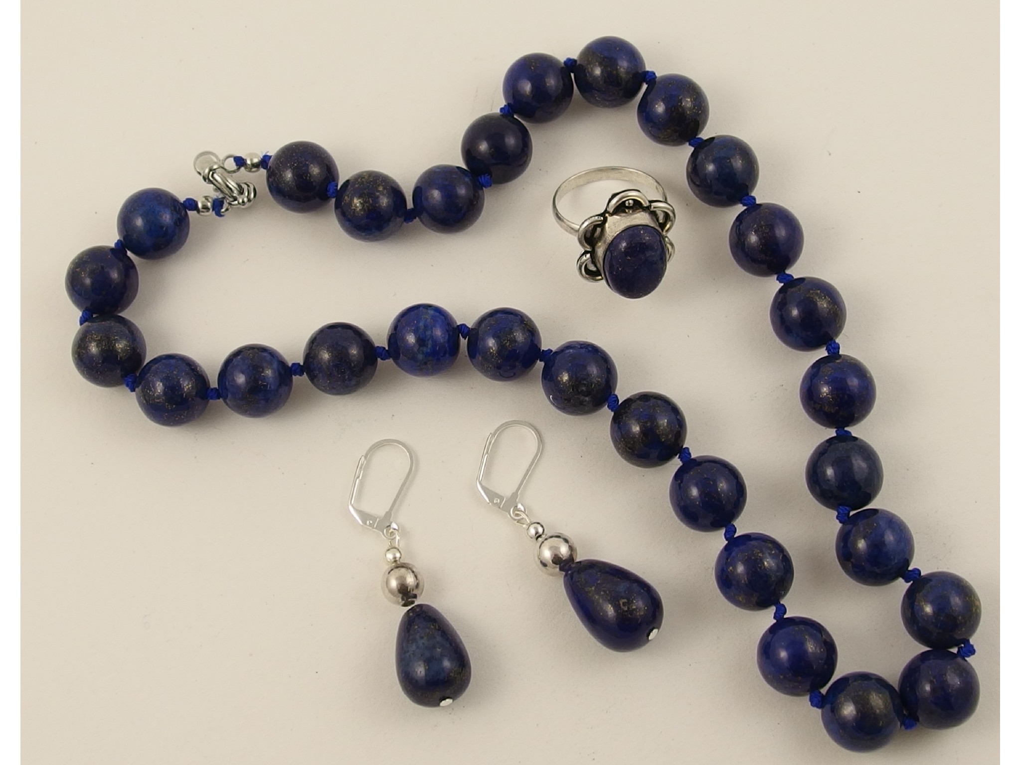 Appraisal: A string of lapis lazuli beads with matching earrings and