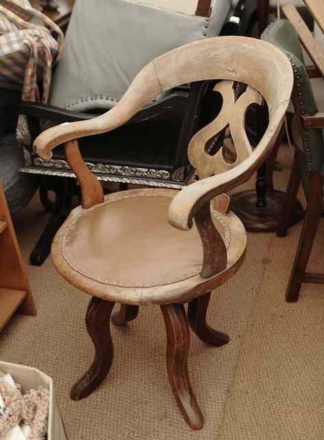 Appraisal: A VICTORIAN OAK AND ASH ROTATING DESK CHAIR with pierced