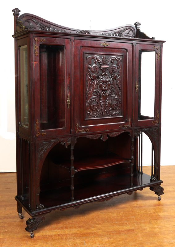 Appraisal: VICTORIAN CARVED NORTHWIND DECORATED CABINET Carved and shaped crest with