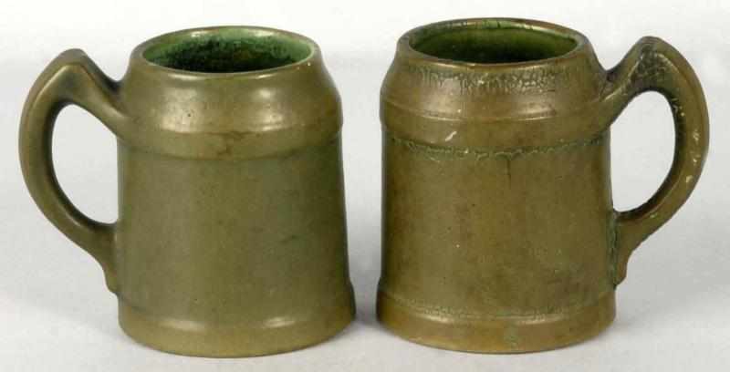 Appraisal: Lot of Matte Green Handled Mugs Description Both with tin