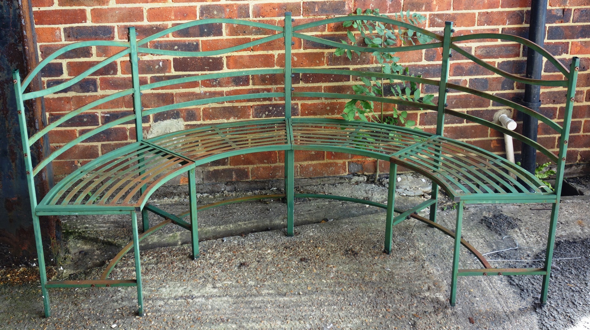 Appraisal: A Regency design green painted metal semi-elliptic garden bench with