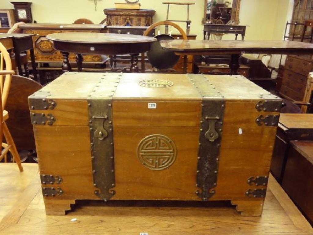 Appraisal: An Eastern camphor wood chest with decorative brass re-inforced corners