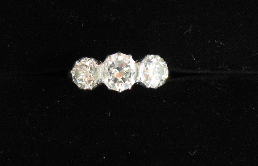 Appraisal: A THREE STONE DIAMOND RING the central round brilliant-cut diamond