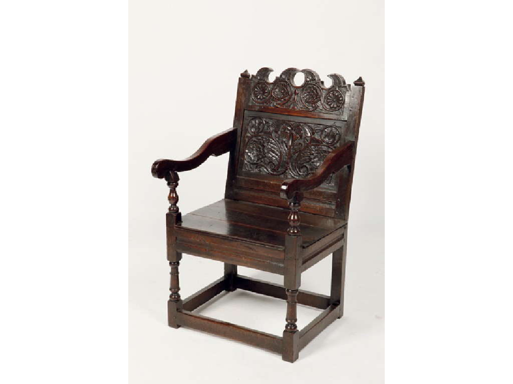 Appraisal: A CHARLES II OAK WAINSCOT ARMCHAIR with a carved and