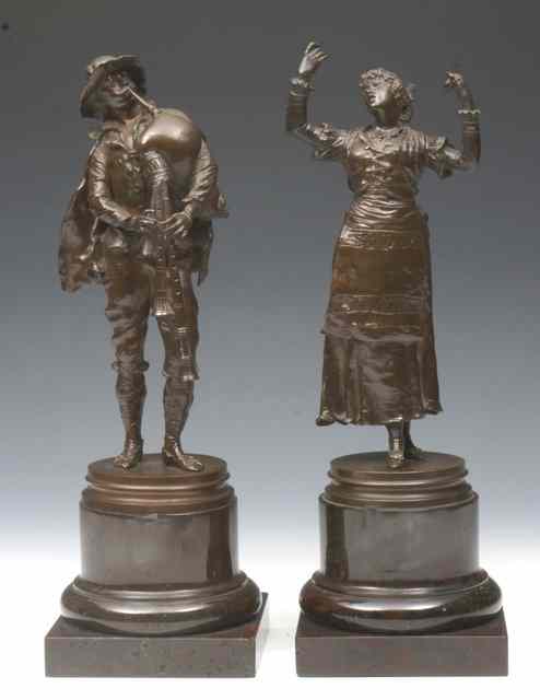 Appraisal: A PAIR OF BRONZE FIGURES showing a man and bagpipes