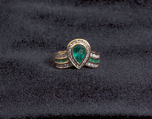 Appraisal: K yellow gold emerald and diamond ring having a pear