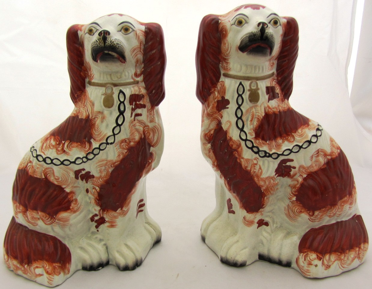 Appraisal: A pair of Staffordshire flatback spaniels late th century red