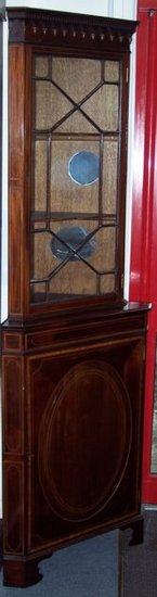 Appraisal: An Edwardian mahogany and inlaid corner cabinet the upper section