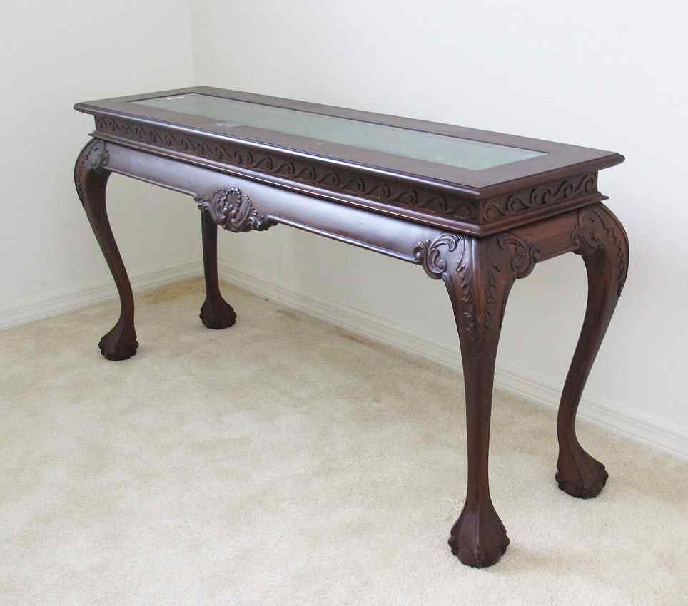 Appraisal: INDONESIAN CARVED MAHOGANY SOFA TABLE In the Chippendale style with