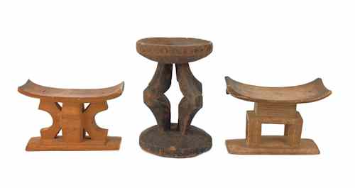 Appraisal: Three carved African wooden seats h h and h