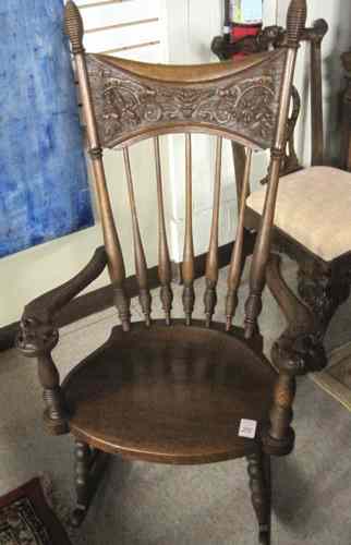 Appraisal: CARVED OAK SPINDLE-BACK ROCKING CHAIR American last quarter of the