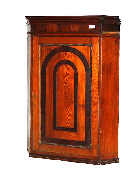 Appraisal: A George III oak and mahogany crossbanded hanging corner cabinet