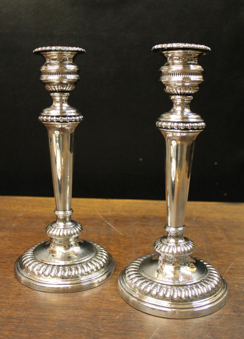 Appraisal: PAIR OF GEORGIAN STERLING SILVER ATTRIBUTED CANDLESTICKS with partially visible