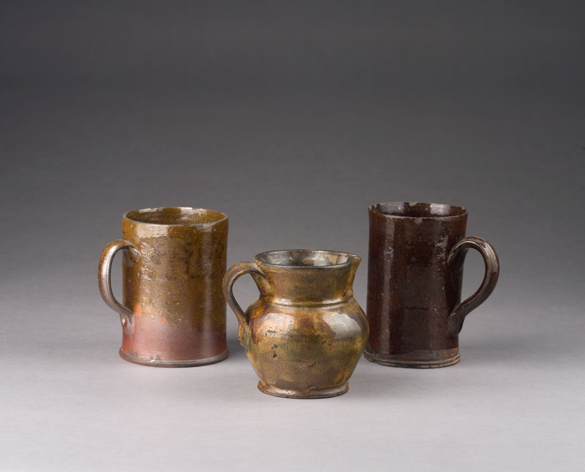 Appraisal: TWO AMERICAN GLAZED EARTHENWARE MUGS AND A PITCHER NINETEENTH CENTURY