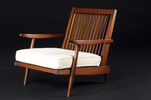 Appraisal: GEORGE NAKASHIMA Walnut spindle-back armchair with fabric cushions Bottom marked