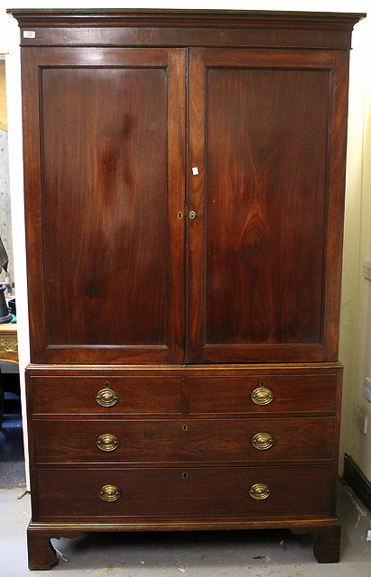 Appraisal: A GEORGE III MAHOGANY LINEN PRESS with twin panelled doors