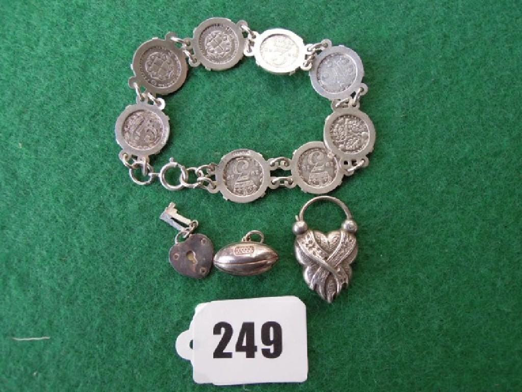 Appraisal: A silver d coin bracelet and three loose silver fobs