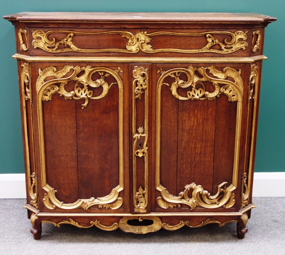 Appraisal: A late th century continental parcel gilt oak side cabinet