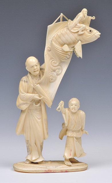 Appraisal: A JAPANESE IVORY OKIMONO of an artist and boy assistant