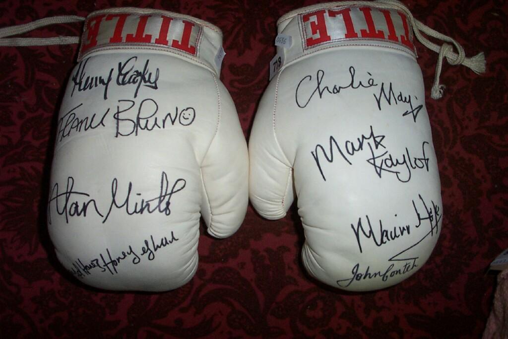 Appraisal: A pair of boxing gloves with signatures including John Conteh